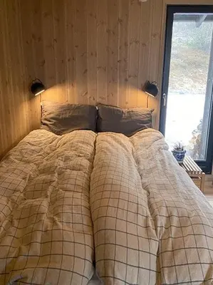 a bed in a bedroom with a blanket on it at Mountain Cabinin Valdres in Aurdal