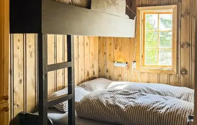a bedroom with a bunk bed and a window at Cabin With Terrace And Mountain Views In Tuddal in Tuddal