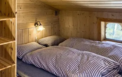 a room with three beds in a wooden house at Cabin With Terrace And Mountain Views In Tuddal in Tuddal