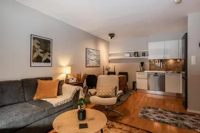 a living room with a couch and a table at Geilo Town Centre - Apartment with a Superb Location and walking Distance to Everything in Geilo
