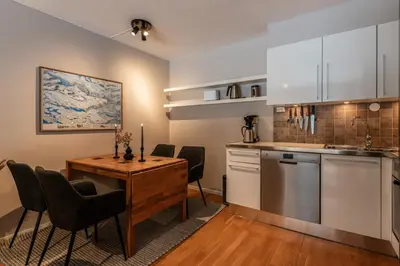 a kitchen and dining room with a table and chairs at Geilo Town Centre - Apartment with a Superb Location and walking Distance to Everything in Geilo