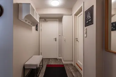 a hallway with a door and a bench and a rug at Geilo Town Centre - Apartment with a Superb Location and walking Distance to Everything in Geilo