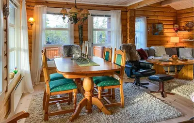 a dining room with a wooden table and chairs at Pet Friendly Home In Lesjaskog With Wifi in Bjorli