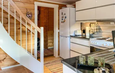 a kitchen with a white refrigerator and a staircase at Pet Friendly Home In Lesjaskog With Wifi in Bjorli