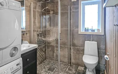 a bathroom with a shower with a toilet and a sink at Nice Home In Rauland With Wifi in Rauland
