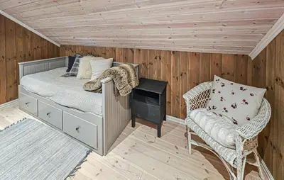 a bedroom with a bed and a chair in a room at Nice Home In Rauland With Wifi in Rauland