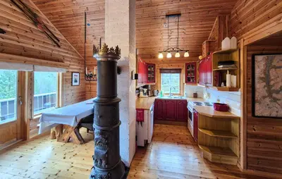 a kitchen with a table and a stove in it at Amazing Home In Skare With Sauna in Skare