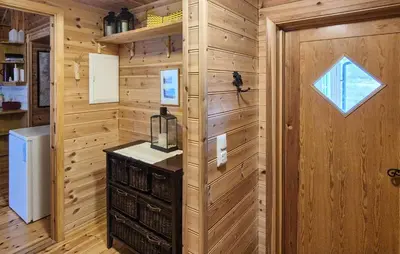 a room with a wooden wall with a window and a door at Amazing Home In Skare With Sauna in Skare