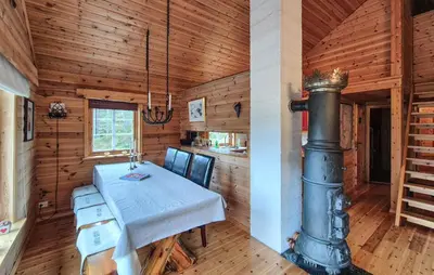 a dining room with a table and a stove at Amazing Home In Skare With Sauna in Skare