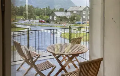 a table and chairs on a balcony with a view at Awesome Apartment In Eidfjord in Eidfjord