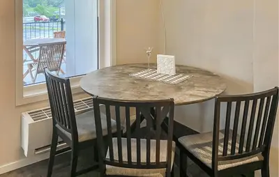 a dining room table with two chairs and a wine glass at Awesome Apartment In Eidfjord in Eidfjord