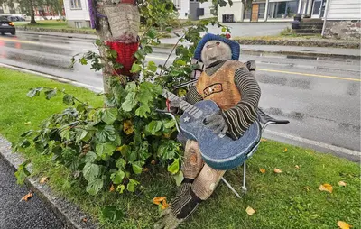 a statue of a monkey playing a guitar on a bench at 3 Bedroom Lovely Apartment In Eidfjord in Eidfjord