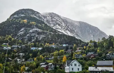a mountain with a town and houses in front of it at 3 Bedroom Lovely Apartment In Eidfjord in Eidfjord