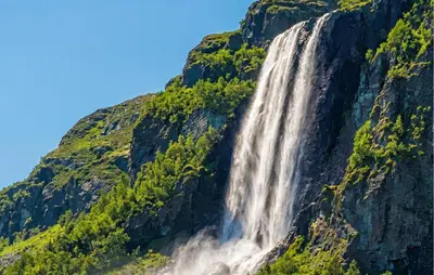 a waterfall on the side of a mountain at Awesome Home In Hemsedal With Sauna in Hemsedal