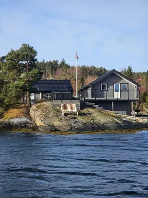 a house on the edge of a body of water at Furiholmen in Askøy