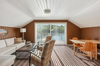 a living room with a couch and a table at Furiholmen in Askøy