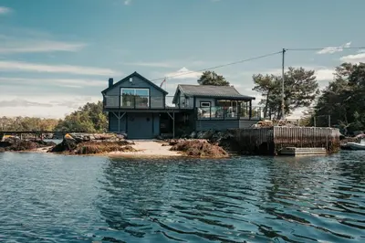 a house on the shore of a body of water at Furiholmen in Askøy