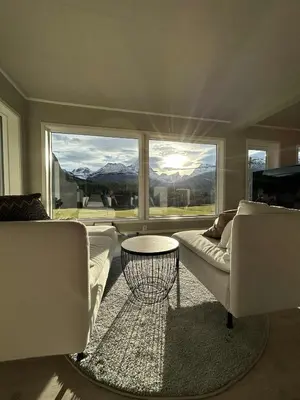 a living room with a couch and a table at Villa Isfjorden in Isfjorden