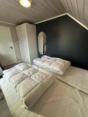 a room with a bed in the corner of a room at Villa Isfjorden in Isfjorden