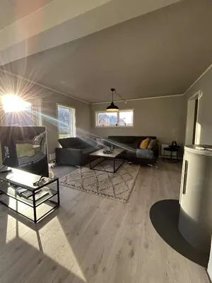 a living room with a couch and a table at Villa Isfjorden in Isfjorden