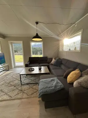 a living room with a couch and a table at Villa Isfjorden in Isfjorden