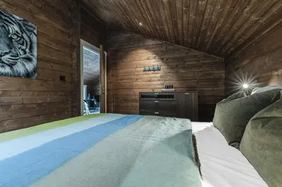a bedroom with a bed in a room with wooden walls at Unique 'Stabbur' in Hemsedal, view to skislopes in Hemsedal