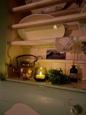 a candle on a shelf with a pot and a candle at Family-Friendly Seter Cabin Near Makalaus Peak in Reinli