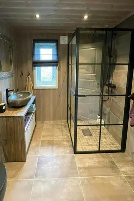 a bathroom with a shower with a glass door at Sunny Cabin With Panoramic Views At Golsfjellet in Tisleidalen