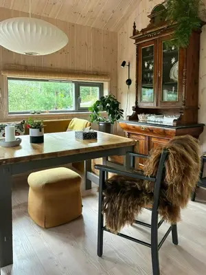 a dining room with a table and a chair at Charming Mountain Cabin In Spectacular Nature in Brunstad