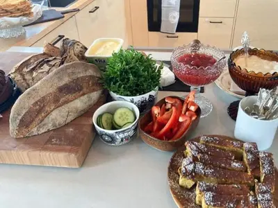 a table with bread and vegetables on a counter at Charming Mountain Cabin In Spectacular Nature in Brunstad