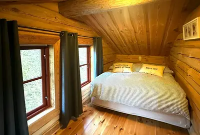 a bedroom with a bed in a log cabin at Log Cabin By Hardangervidda National Park in Nesland