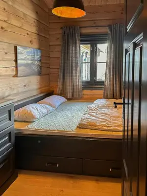 a bedroom with a bed in a log cabin at Large Dream Cabin On Vegglifjell in Veggli