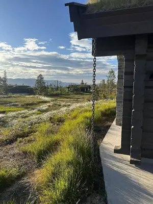 a porch with a chain hanging from a house at Large Dream Cabin On Vegglifjell in Veggli
