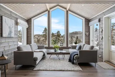 a living room with two couches and large windows at Modern Cabin Near Maldalsvatnet And Reinsnuten in Sauda