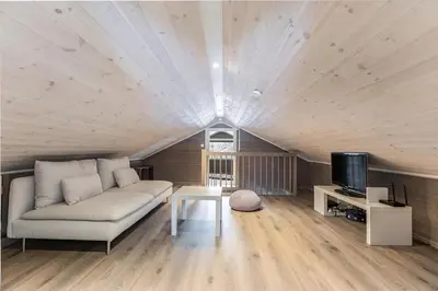 a living room with a couch and a tv at Modern Cabin Near Maldalsvatnet And Reinsnuten in Sauda