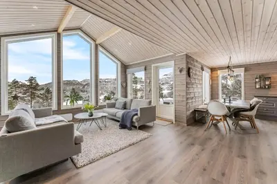 a living room with a couch and a table at Modern Cabin Near Maldalsvatnet And Reinsnuten in Sauda
