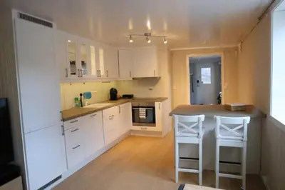 a kitchen with white cabinets and a counter top at Central apartment in Lillehammer in Lillehammer