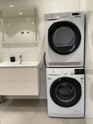 a kitchen with a washing machine and a sink at Central apartment in Lillehammer in Lillehammer