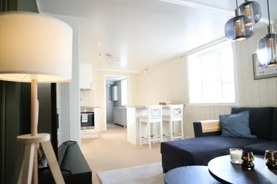 a living room with a blue couch and a table at Central apartment in Lillehammer in Lillehammer