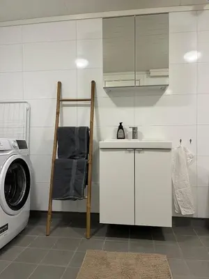 a kitchen with a sink and a washing machine at Panoramic mountain views, space for the whole family in Vossevangen