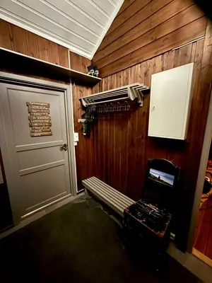 a room with a door and a bench next to a door at Utibakken - cabin ski inn-out Norefjell in Surteberg