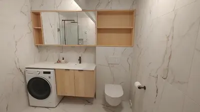 a bathroom with a sink and a washing machine at Splitter ny leilighet i sokkel på enebolig in Vikhammer