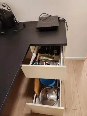 a desk with a black counter top with a drawer at Nice Apartment in Sjetnemarka - Free parking and WiFi in Trondheim