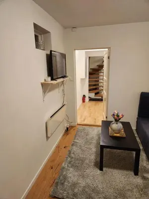 a living room with a couch and a table at Nice Apartment in Sjetnemarka - Free parking and WiFi in Trondheim
