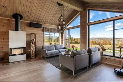 a living room with two couches and a fireplace at New Cabin With Views Of Tisleiefjorden in Gol