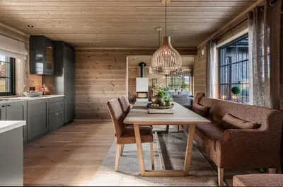 a dining room with a table and a couch at New Cabin With Views Of Tisleiefjorden in Gol
