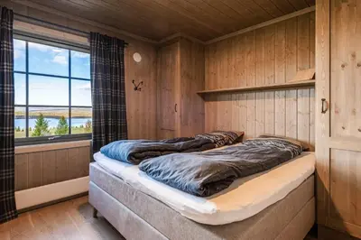 two beds in a room with a window at New Cabin With Views Of Tisleiefjorden in Gol