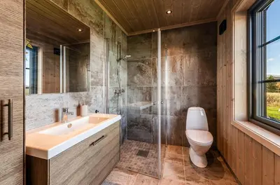 a bathroom with a sink and a toilet and a shower at New Cabin With Views Of Tisleiefjorden in Gol