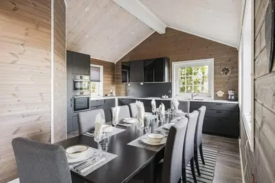 a dining room with a table and chairs in a kitchen at Jantelaaven in Trysil