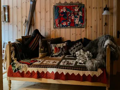 a wooden couch with a blanket on it in a room at Family Cabin From 1968 At Norefjell in Noresund